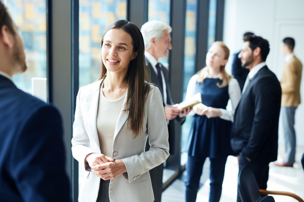 Pretty business lady talking to colleague