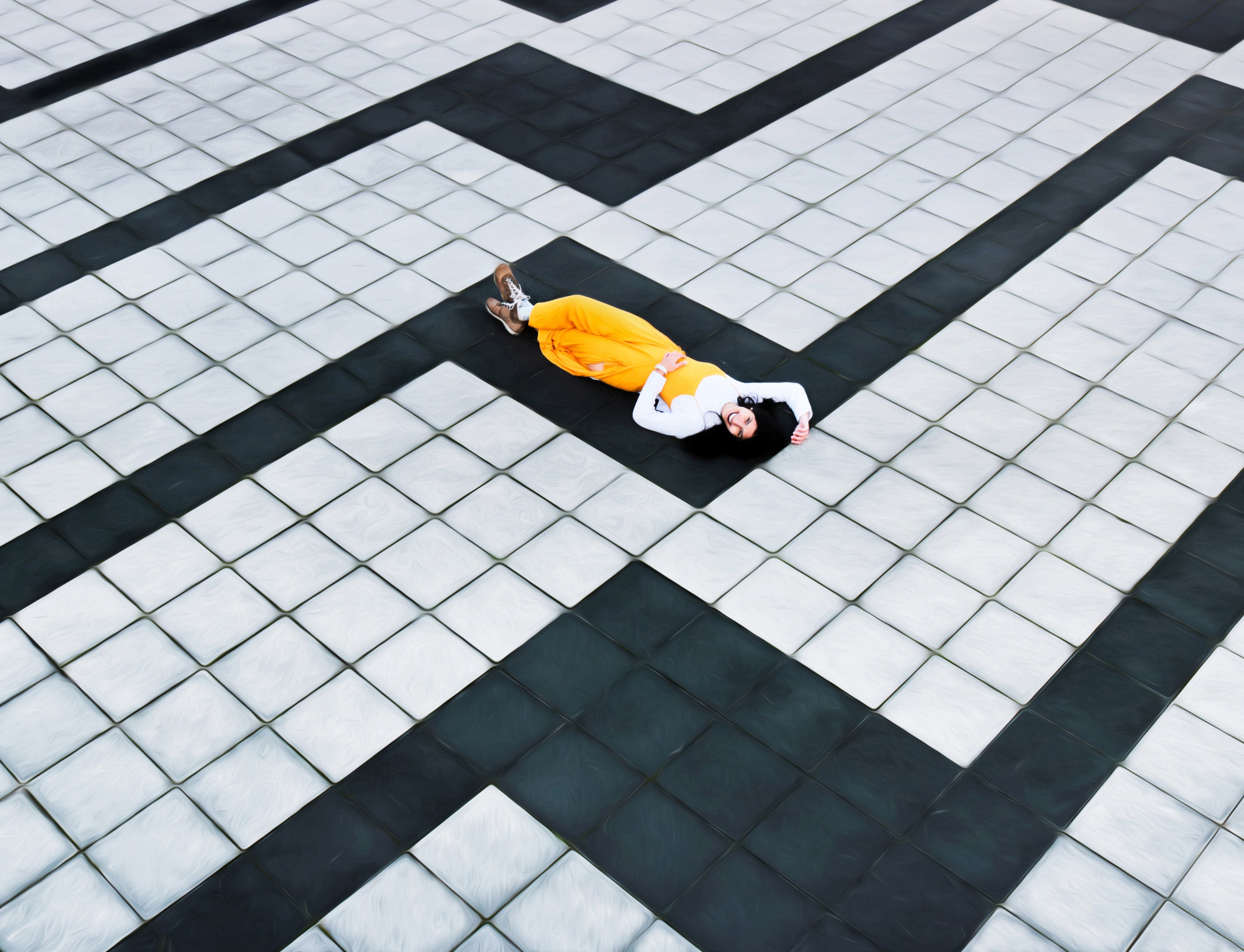 woman-in-yellow-pants-lying-on-concrete-tiled-floor-3455450