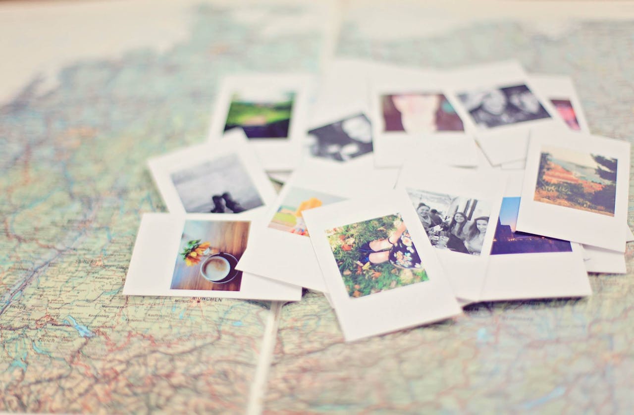 A bunch of Polaroid photos on a map.